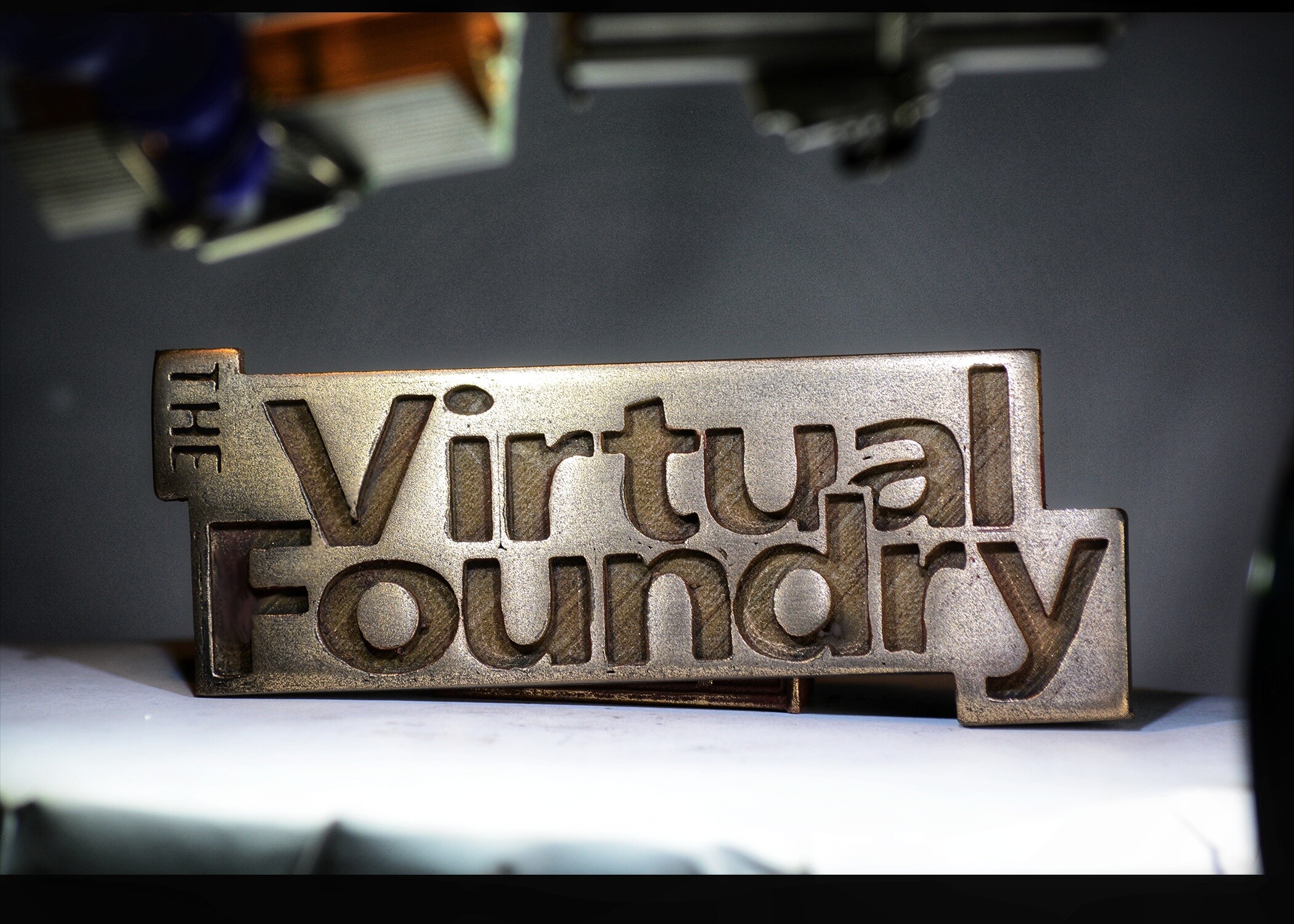 Metal Filament A sign displaying the word "Virtual Foundry" promoting their innovative metal 3D printing using fffmetal technology.
