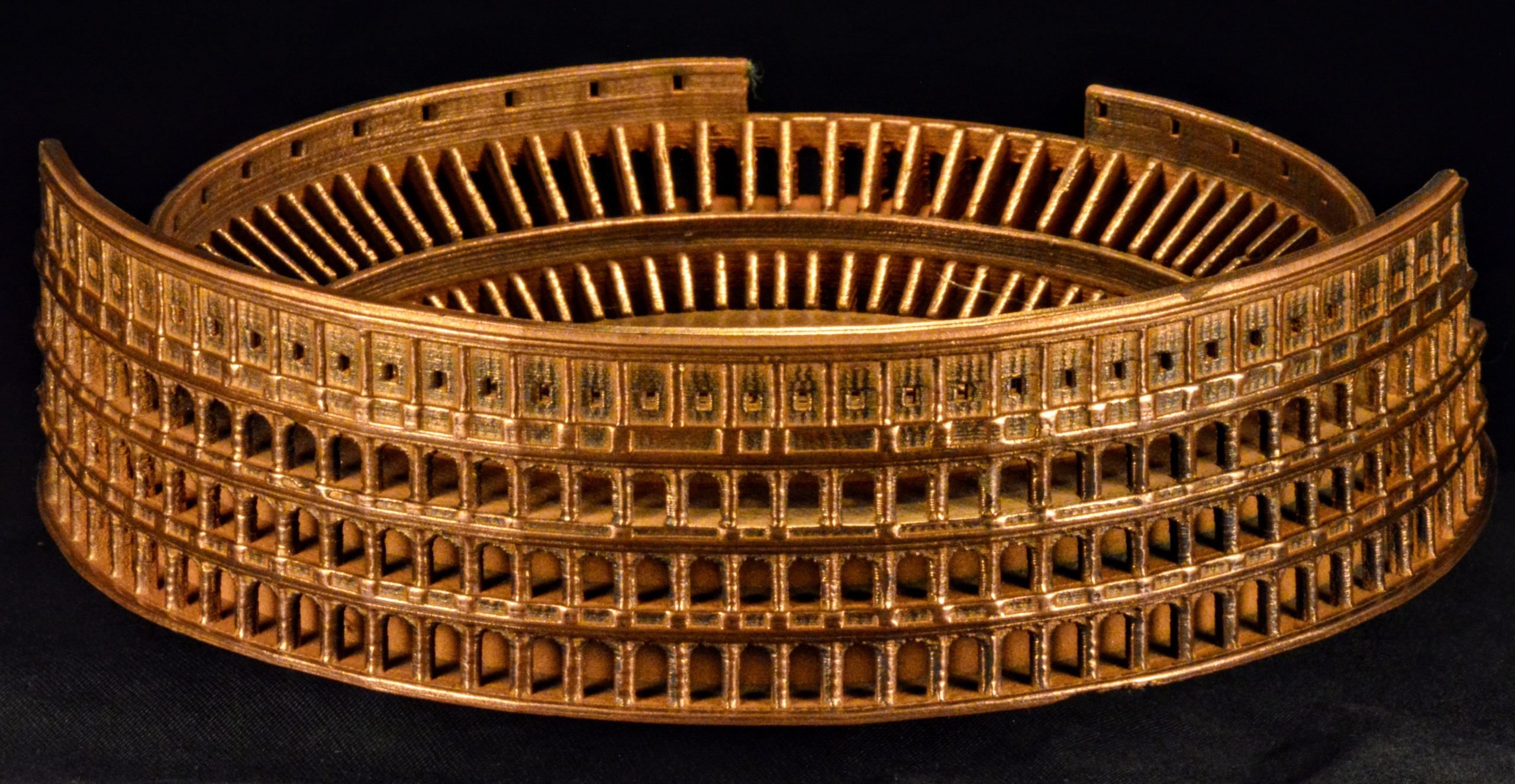 3D printed model of the Roman Coliseum, showcasing intricate architectural details, emphasizing the capabilities of FFF Metal technology.
