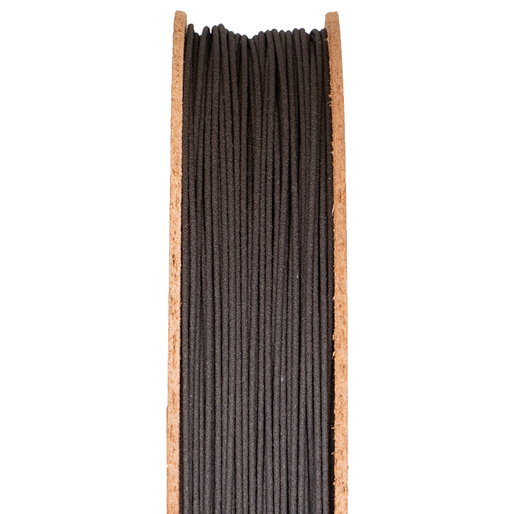 High-carbon iron 3D printing filament on a spool, showcasing its dark texture, relevant for advanced sintering processes in metal and ceramic 3D printing.