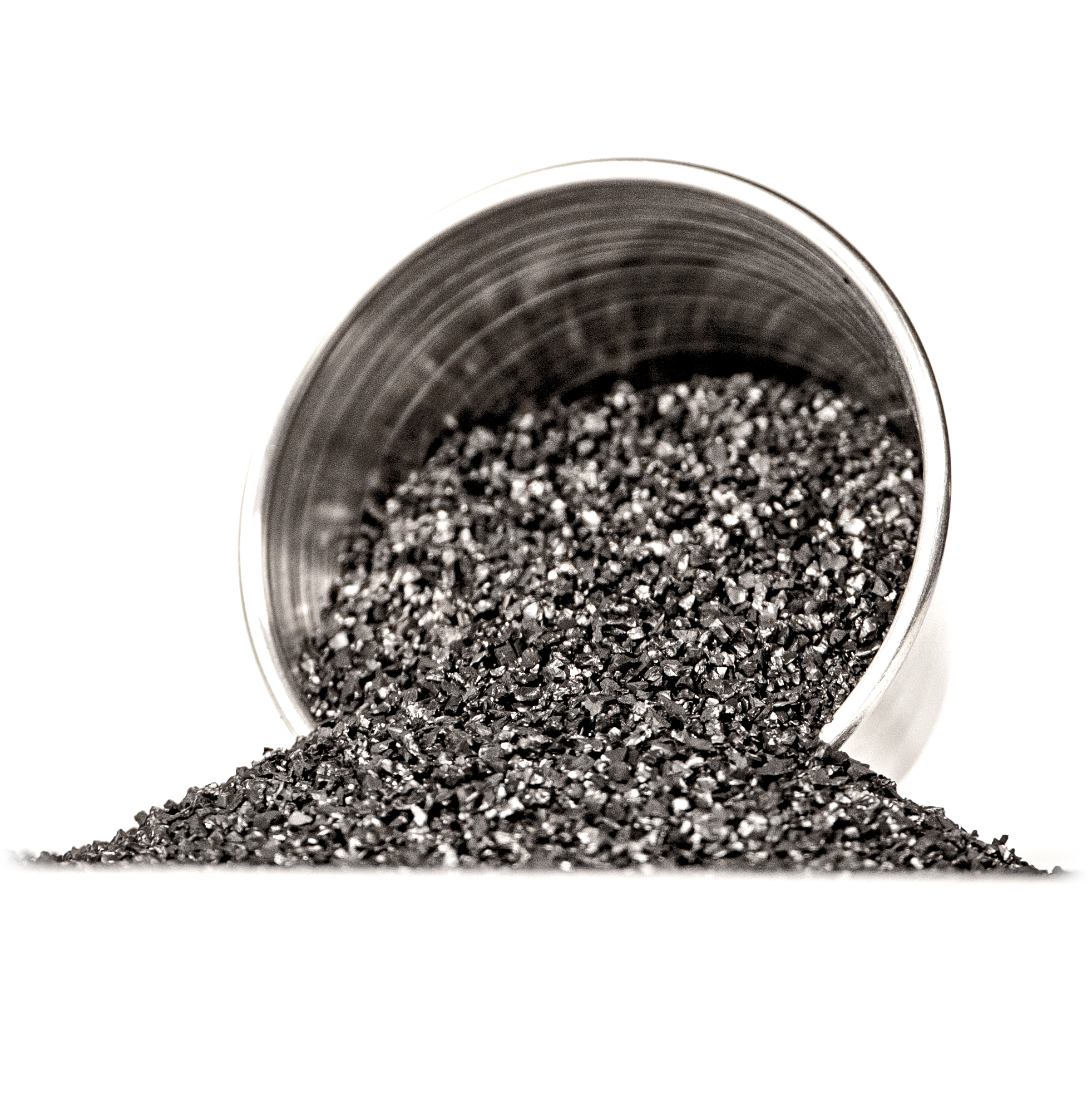 Sintering carbon powder spilling from a metallic container, relevant to 3D printing materials and sintering processes.