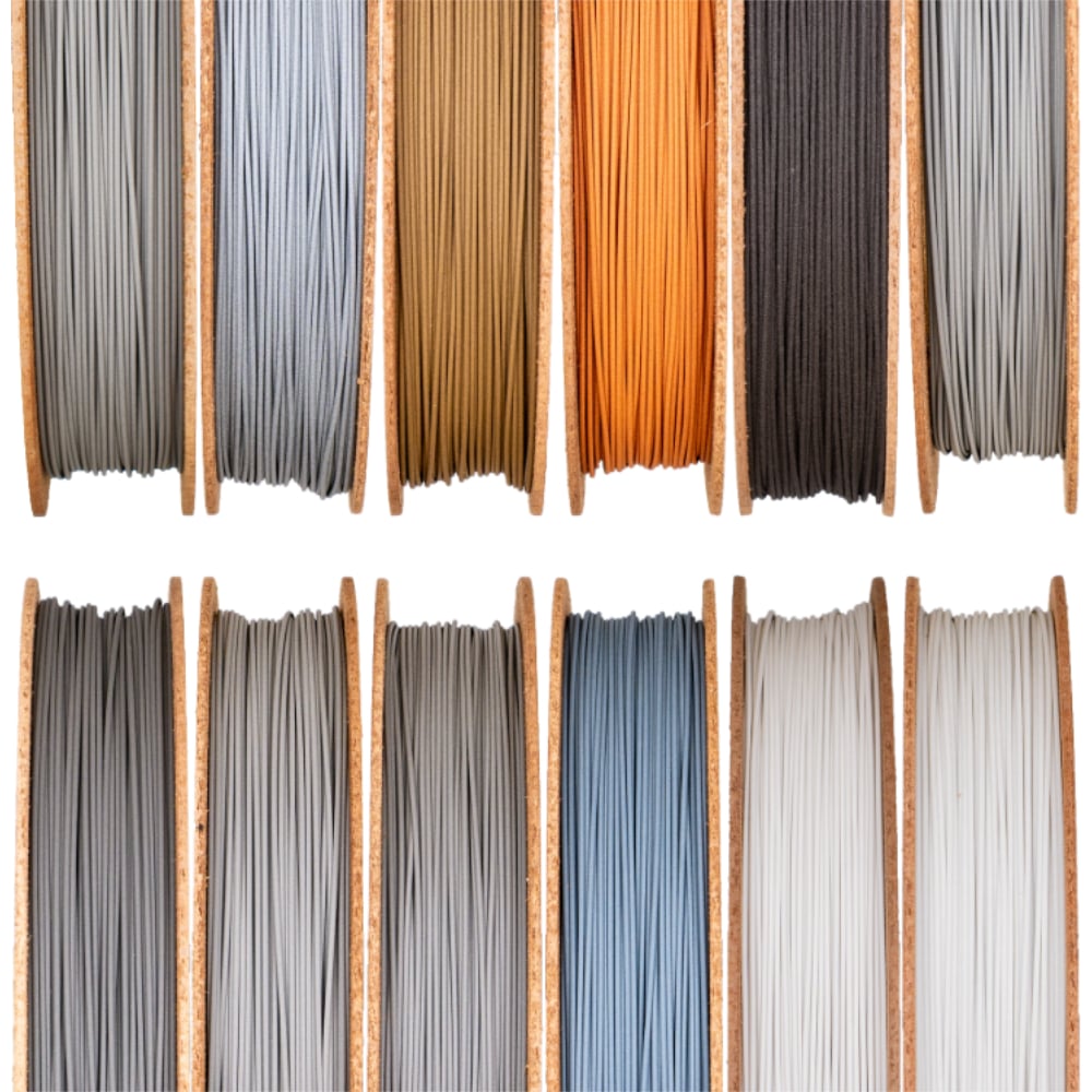 Spools of various colored Filamet™ 3D printing filament, showcasing options for creating pure metal parts.