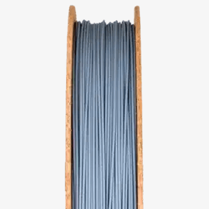 Ceramic 3D printing filament on a spool, showcasing the material designed for easy use with standard 3D printers, relevant to The Virtual Foundry's Filamet™ product line.